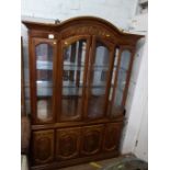 A large display cabinet. 20th century. With a pair of doors enclosing glass shelves.