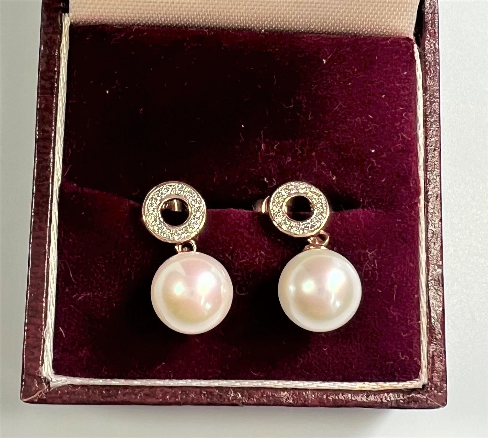A Pair of 9ct rose gold pearl and diamond drop earrings