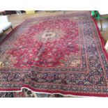 A large red ground fine woven Persian carpet, Kashan region of Iran. 395cm x 295cm.