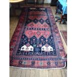 A Persian Hamadan Lori tribal rug depicting people and animals. 345cm x 157cm.