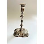 An Edwardian Sterling Silver Taper stick. In George III style. London 1904. loaded. 14cm high.