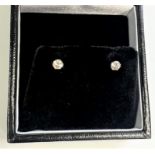 A Pair of 18ct white gold solitaire diamond studs