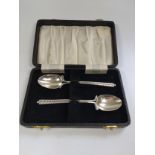 A cased pair of silver London 1917 golf themed design 'his & hers' teaspoons.