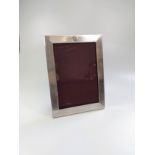 A silver Birmingham 1944 photo frame with engine engraved design size 11.5cm x 17cm