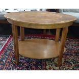 An Art Deco low coffee table with shaped top, fluted legs and inlaid top and under tier 50cm x