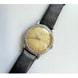 A Longines 1950's Stainless Steel Manual Wind Gentleman's Wrist Watch. On a black leather strap,