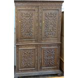 An Antique ornately decorated cabinet on chest with bun feet. In renaissance style. 22