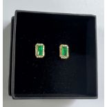 Pair 18ct yellow gold rectangular emerald and diamond cluster studs
