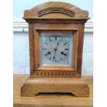 A Carved Oak mantel clock (number 5867). Together with keys and a pendulum. Circa 1910
