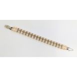 A cultured pearl bracelet set with white stones. 16cm long.