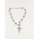 An Amethyst and white stone set necklace. Early 20th century. 24cm drop.