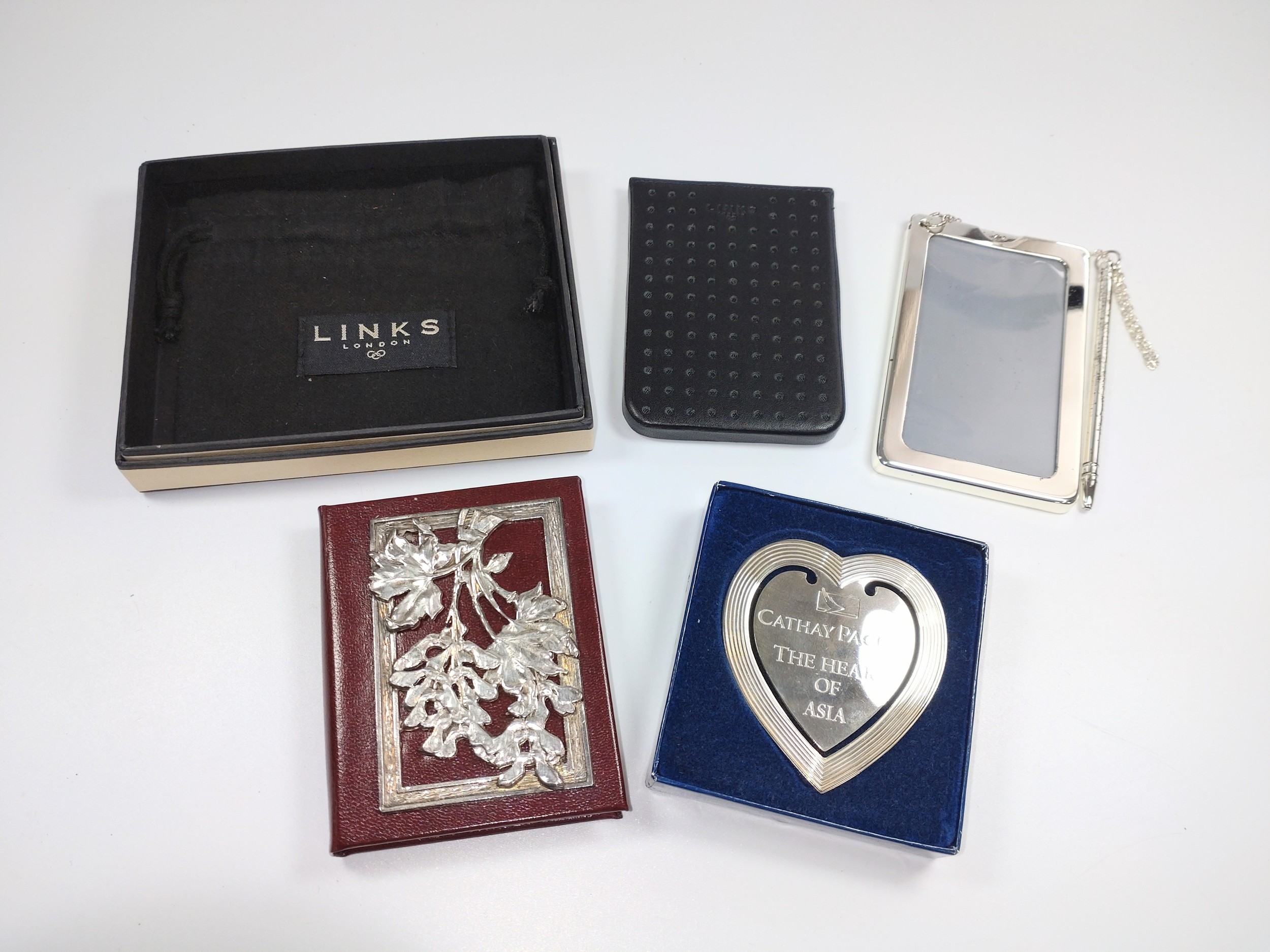 A Links London silver-plate note pad with case together with Cathay Pacific heart shaped bookmark