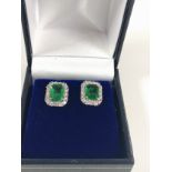 Pair of 18ct white gold rectangular cluster earrings set with emerald-cut emeralds and diamond