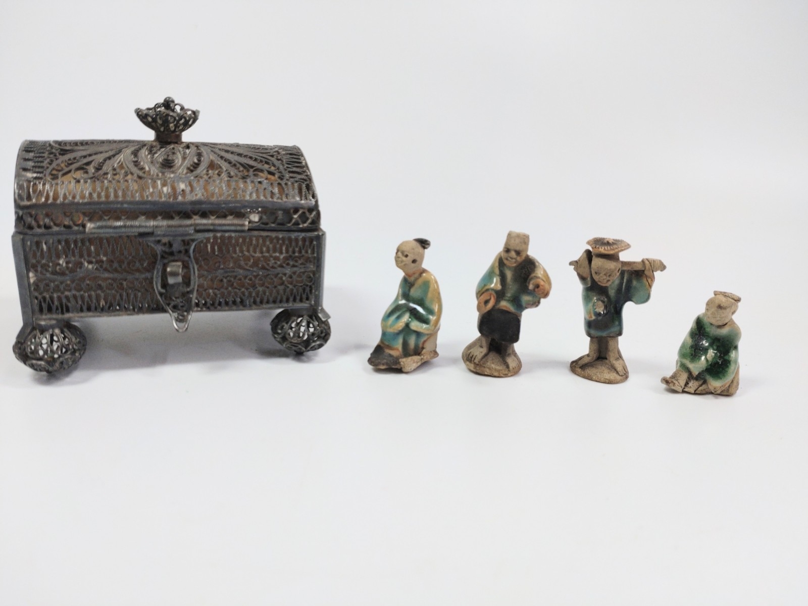 A filigree casket with tiny Chinese figurines