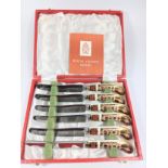A Set of Six Tea knives with steel blades and royal crown Derby Handles. Cased)