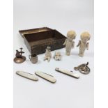 A cigarette box containing two small Victorian dolls, two mother of pearl fruit knives, a mother