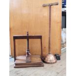 A book press and a copper wash plunger. Vintage.