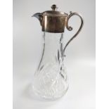 A silver plated mounted cut glass claret jug. Inscribed. 28cm high.