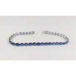 18ct white gold oval sapphire line bracelet, boxed. Sapphires 10.87ct. 180mm long. 8.21 grams.