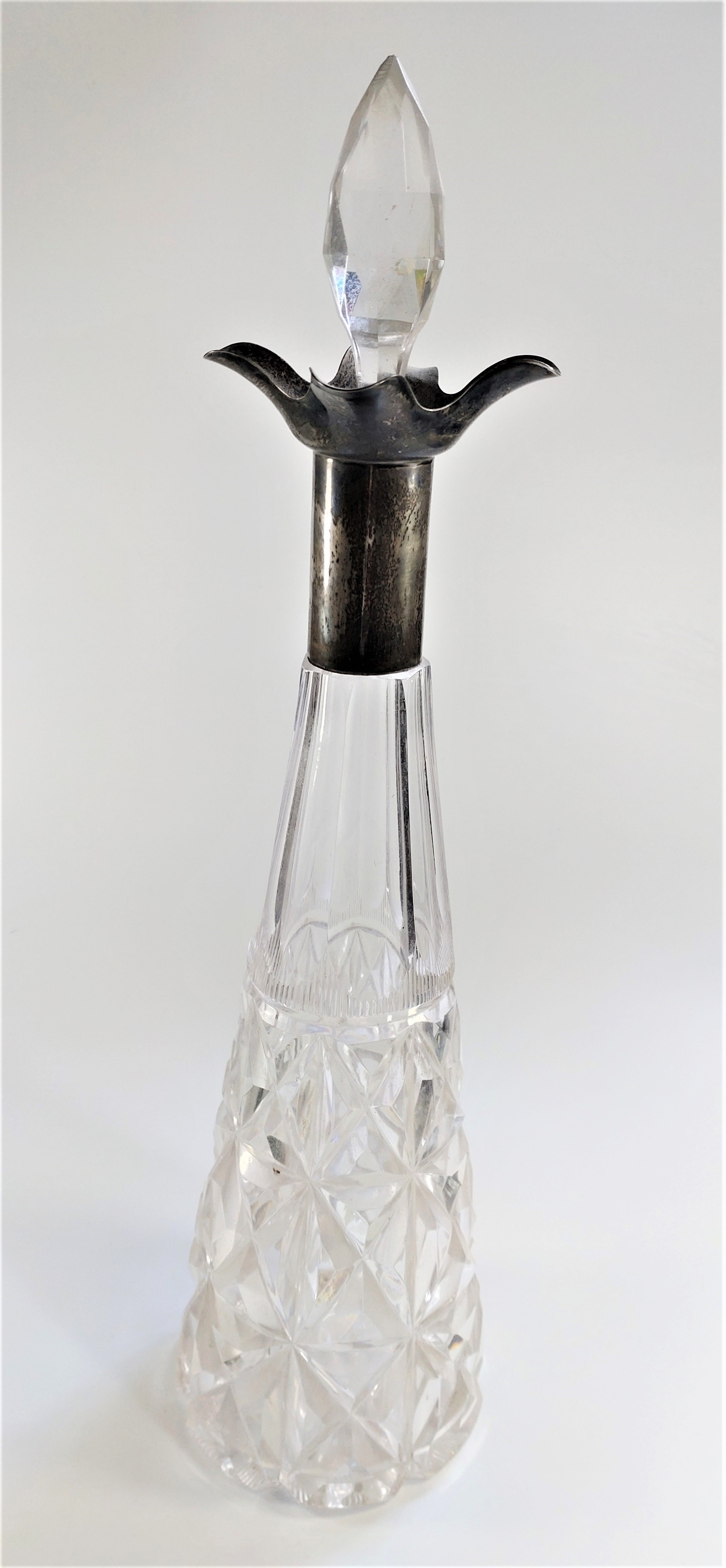 A silver mounted decanter. Of conical form. With Stopper. Sheffield 1931. 43cm high.