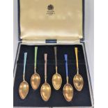 A Set of six Gilt Metal and Enamel coffee spoons. (cased)