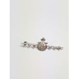 A diamond brooch set in high cart white metal. 50mm long. 3.65 grams.