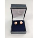 Pair of 9ct yellow gold round pink cultured pearl studs, boxed.