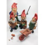 Three terracotta garden gnomes 24cm to 26cm and a painted concrete gnome 31cm. (4)