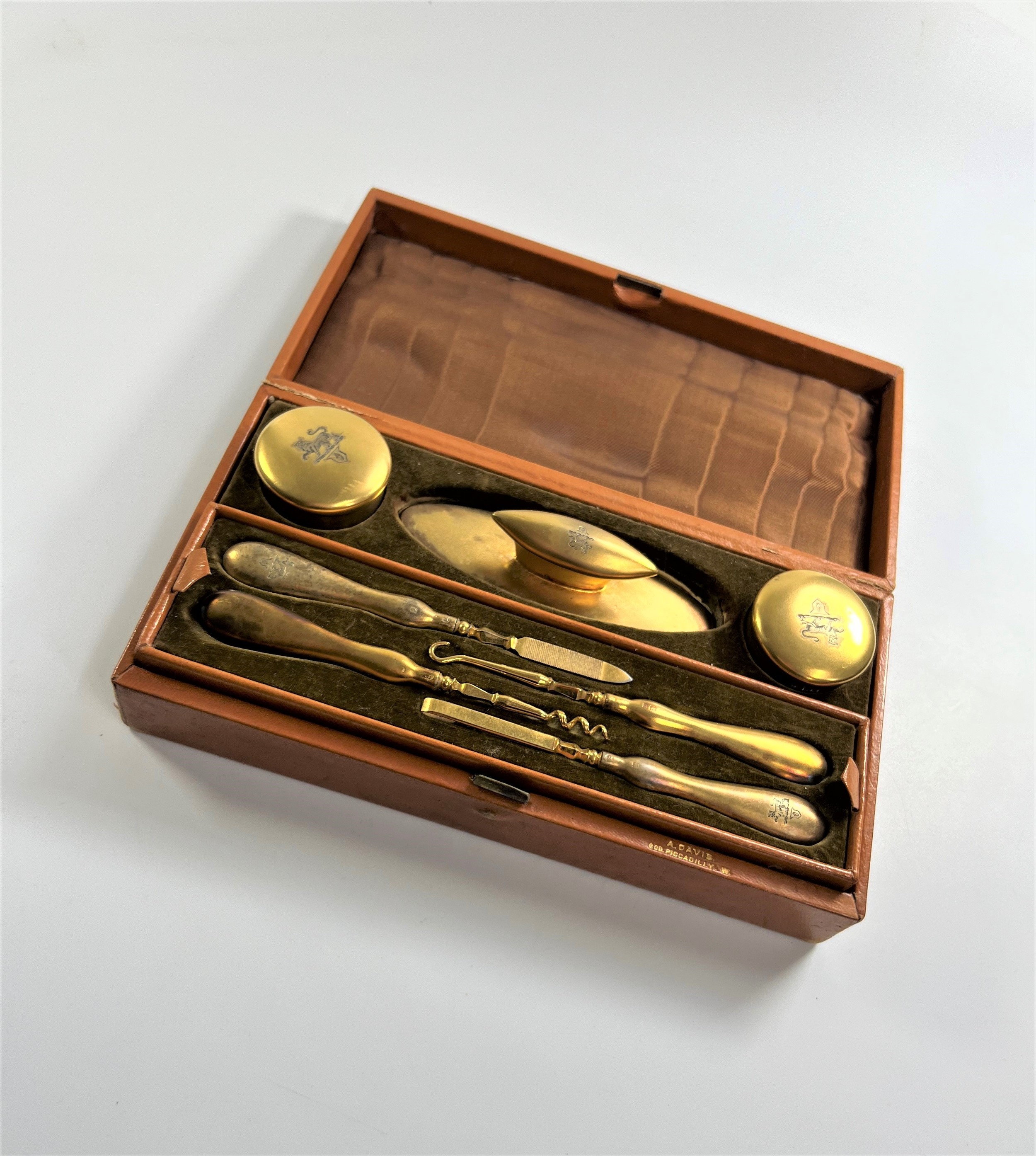 An Edwardian Silver Gilt lady's Manicure Set. London 1903. Comprising two jars, a nail buffer, and