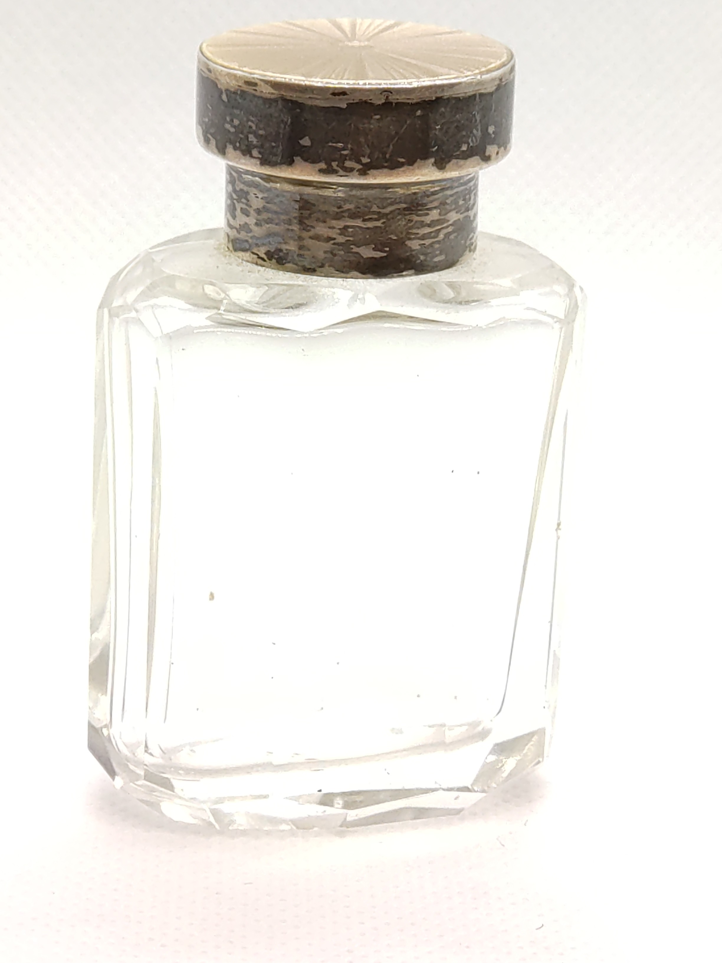 A silver and enamel scent bottle complete with stopper. 6.5sm high.