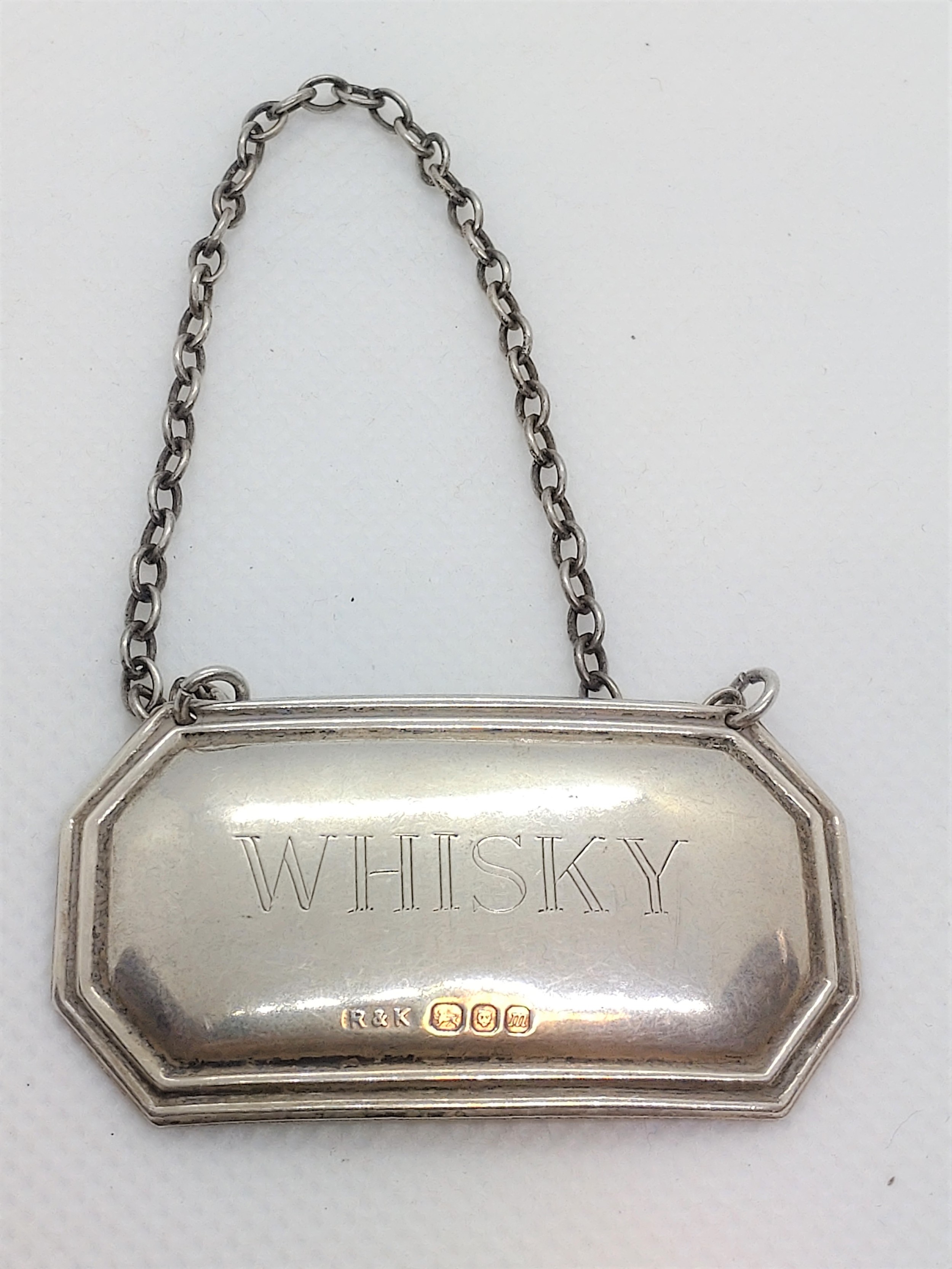 A modern sterling silver decanter label for whisky