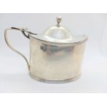 A George III sterling silver oval mustard pot, Robert Hennell 1804. Quite plain with blue glass