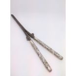 A pair of wrought iron and silver mounted glove stretchers. London 1895.