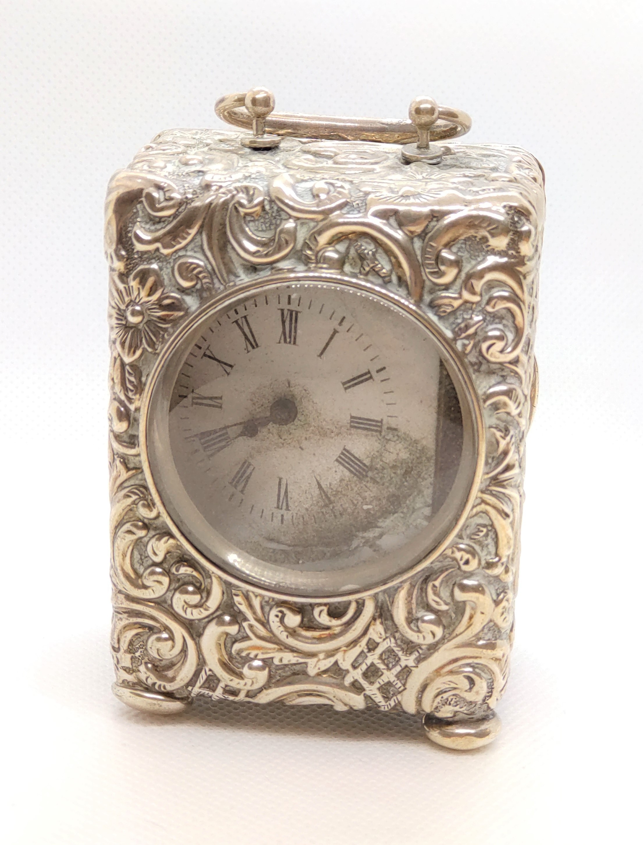 A Victorian sterling silver cased desk timepiece. Birmingham 1898. In need of restoration. 8cm high.