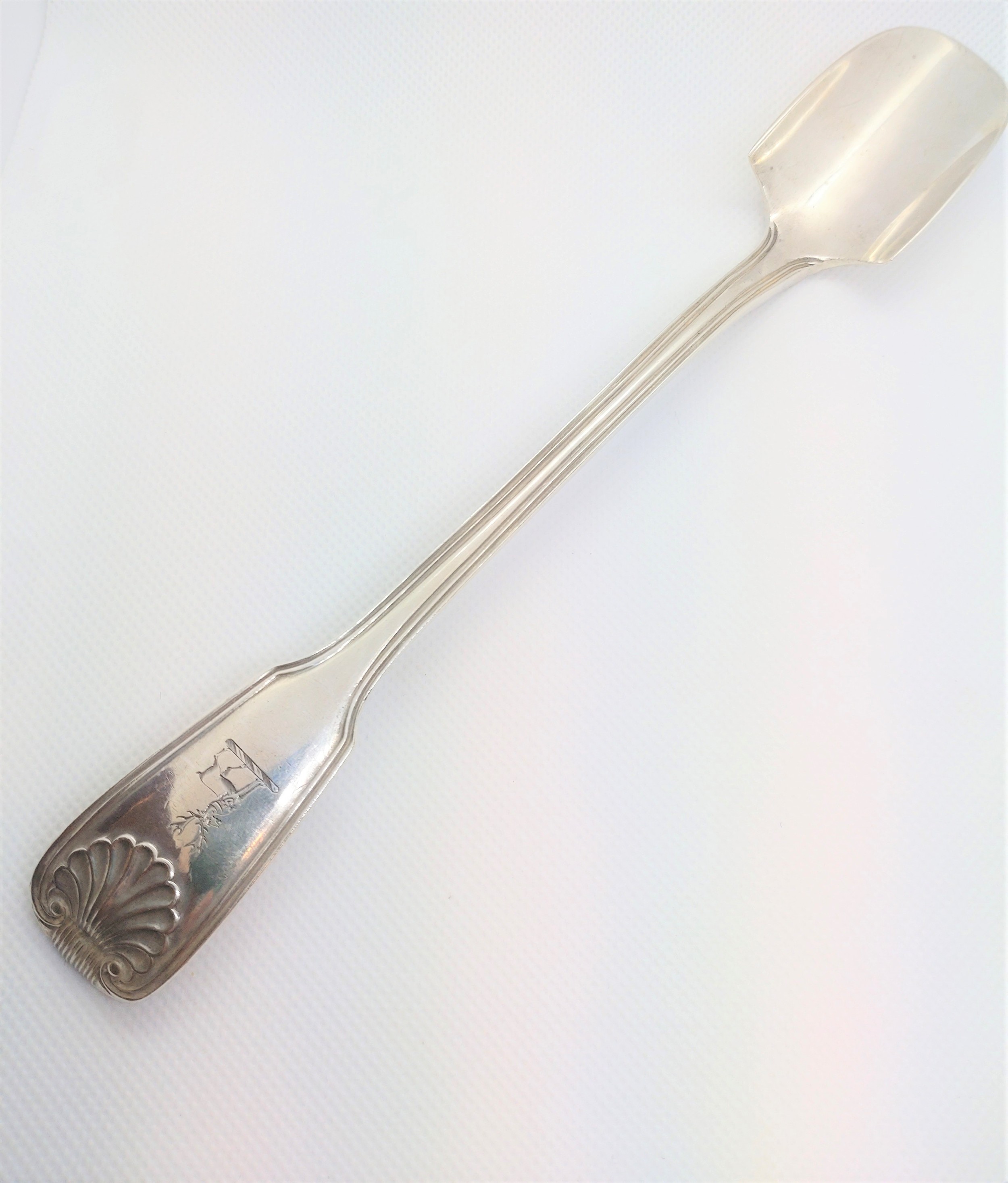 A Victorian sterling silver fiddle thread and shell cheese scoop. George Adams, London 1872.