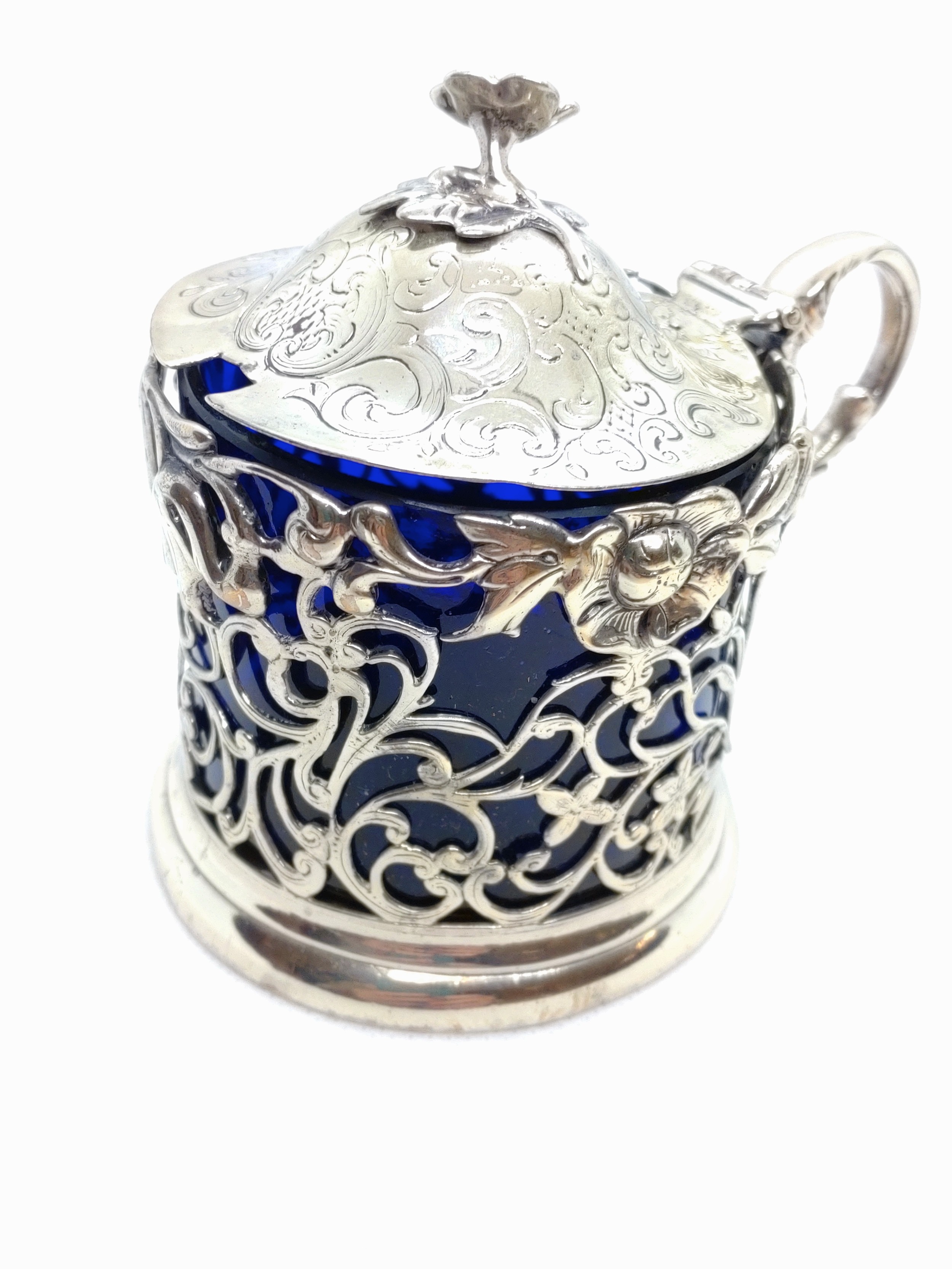 A Victorian sterling silver mustard pot messrs. Angel. 1841 with blue glass liner. 10cm high. 144.