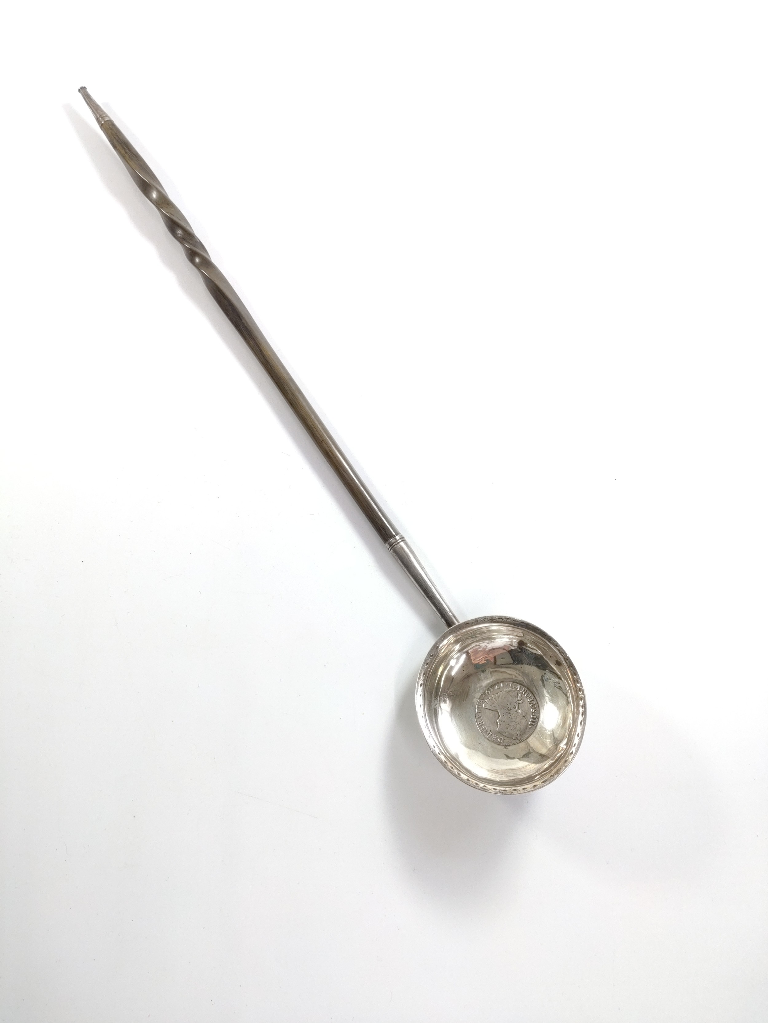 A George III sterling silver toddy ladle with whale bone twist handle. Apparently unmarked but inset