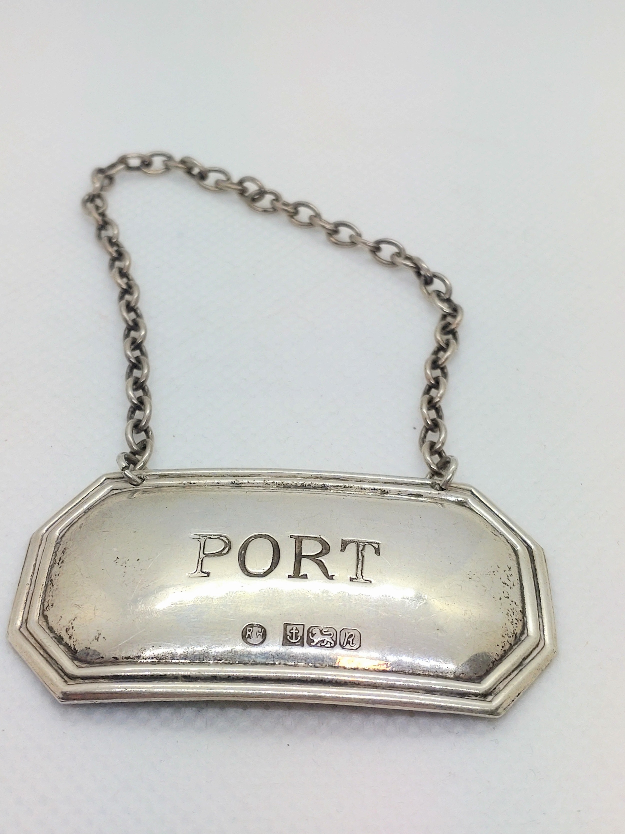 A modern sterling silver decanter label for port.