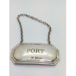 A modern sterling silver decanter label for port.