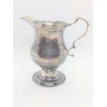 A George III sterling silver cream jug, London 1771. Quite plain. 10.5cm high. 78gms.