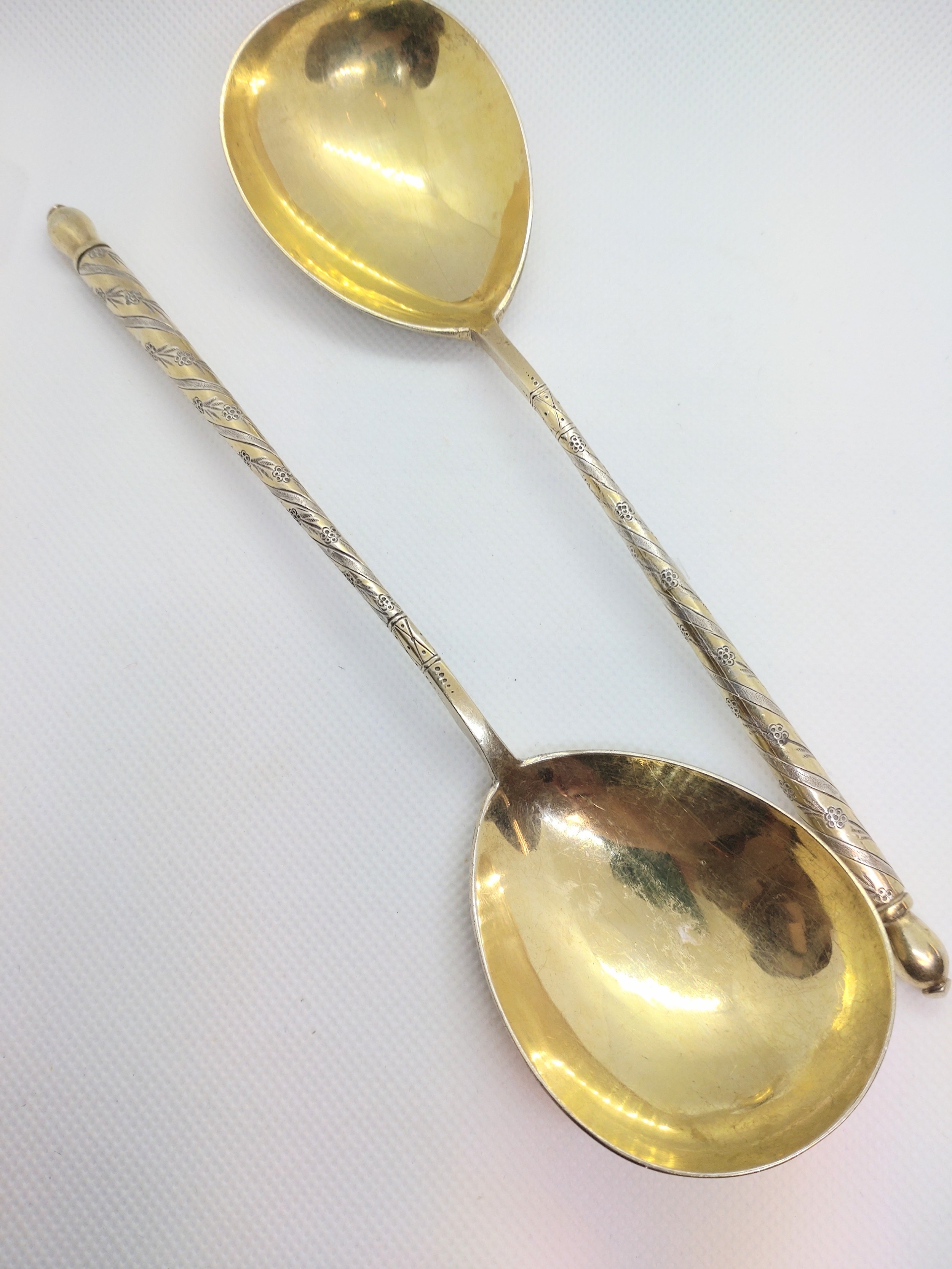 A pair of Elkington and Co. silver-plated gilt spoons.