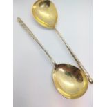 A pair of Elkington and Co. silver-plated gilt spoons.