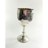 A large Victorian sterling silver goblet engraved with sprigs of flowers on a knopped stem and