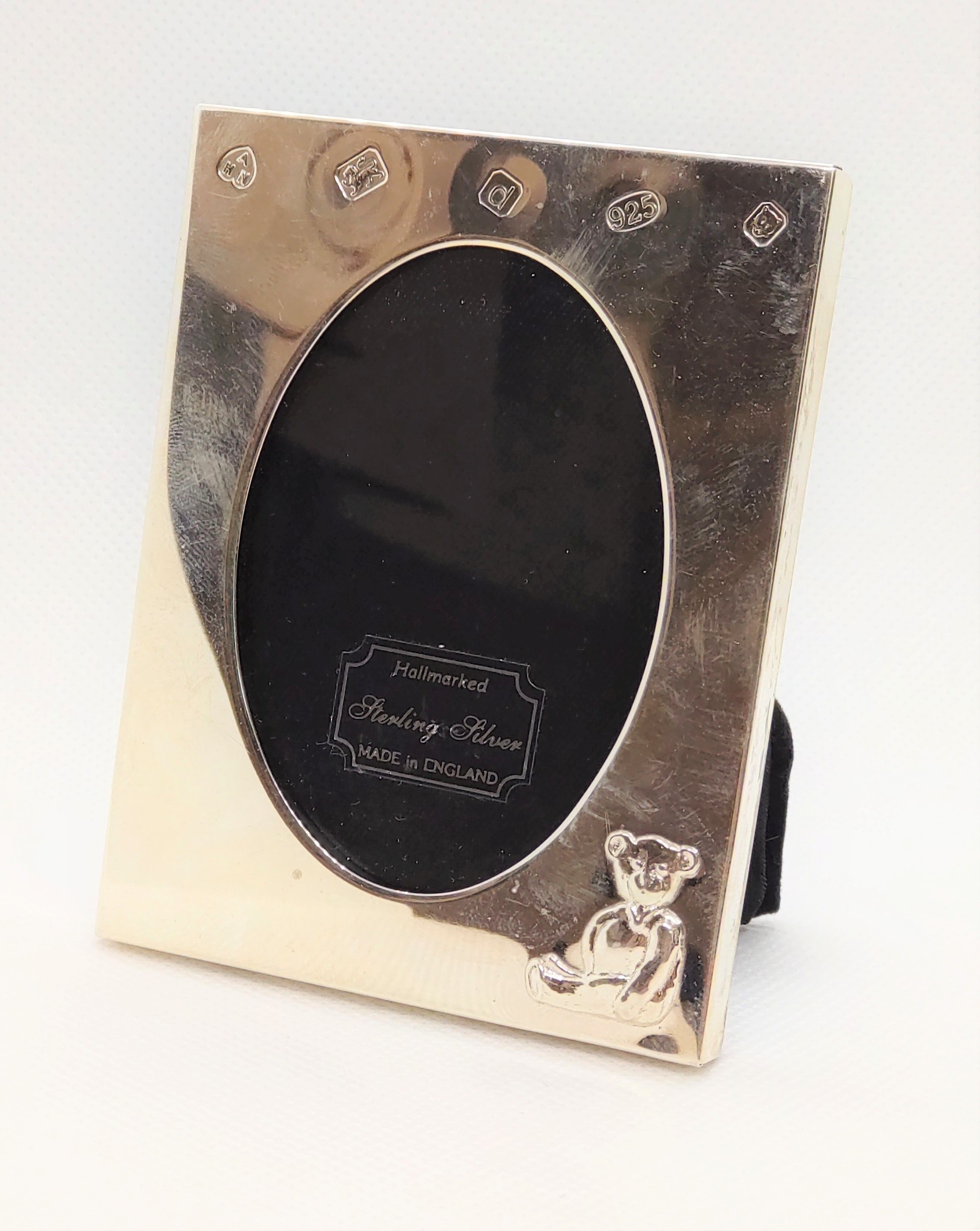 A modern silver mounted photograph frame embossed with a teddy bear. 9cm high.