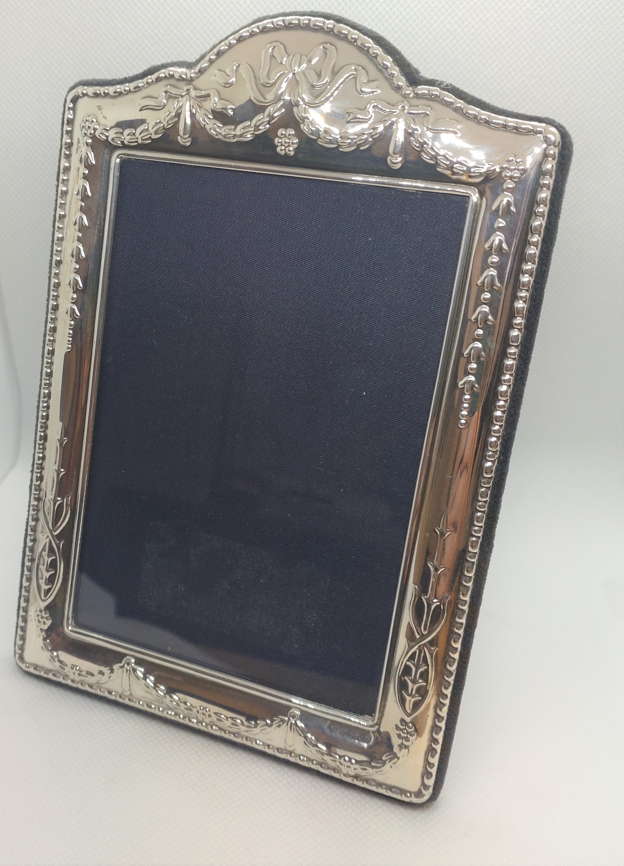 A silver mounted photograph frame. Modern. Sheffiled hallmarks. 18cm high.