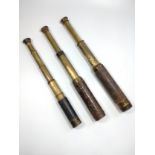 Three antique or vintage telescopes