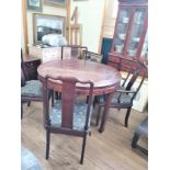 A Vintage Chinese Rosewood Circular Dining table and 10 chairs.