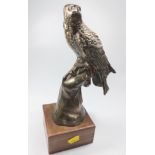A cast white metal figure if an eagle on a wooden plinth, early 20th century. 29cm high.