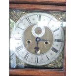 An Oak Longcase Clock. With brass dial and silvered chapter ring. With pendulum and weights.