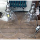 Two modern glass lampshades with ceiling fittings